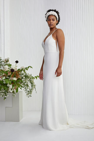 Looking for a classic look with a little more... Made in a comfortable silk crepe, this understated yet memorable dress epitomizes modern femininity from its sleek spaghetti straps and plunge illusion neckline, to its fitted gentle A-line silhouette finished with silk-covered buttons.