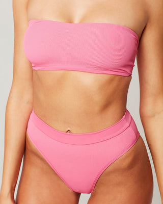 Nothing says high and mighty like the Ribbed Frenchi Bottom. This hip-bearing high-waist bottom features a sexy high-leg, ribbed texture fabric, and bitsy coverage perfect for the ultimate beach bombshell. Designed by L*Space Swim, we love this bubblegum pink bikini for summer or your next tropical beach vacation. 