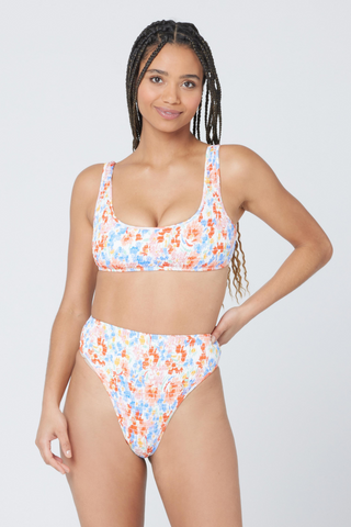 Once you slip the Izzie Top on you'll wonder how you ever lived without it. Featuring a flattering, smocked style, this pullover top is quite possibly the comfiest bikini top ever. Designed by L*Space, we love the Flowers Forever print for this swim season and your next vacation getaway. 