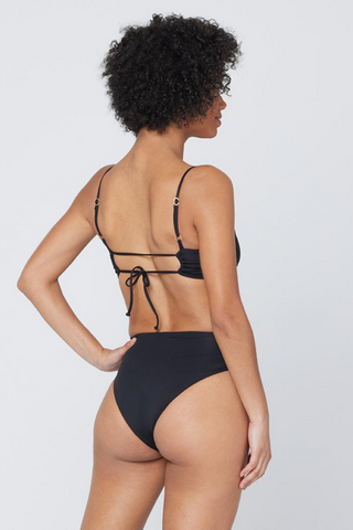 The Nancy Lee is a vintage-inspired bottom with bold style and a twist front detail. A high waist is balanced with a sexy high cut leg and bitsy coverage. Designed by L*Space, this black bikini bottom hits in all of the right places for a flattering fit, need we say more?