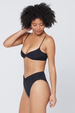 The Nancy Lee is a vintage-inspired bottom with bold style and a twist front detail. A high waist is balanced with a sexy high cut leg and bitsy coverage. Designed by L*Space, this black bikini bottom hits in all of the right places for a flattering fit, need we say more?