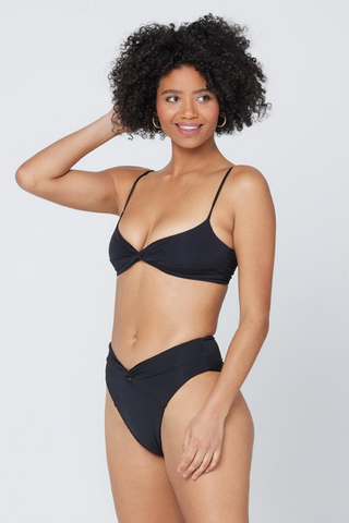 The Nancy Lee is a vintage-inspired bottom with bold style and a twist front detail. A high waist is balanced with a sexy high cut leg and bitsy coverage. Designed by L*Space, this black bikini bottom hits in all of the right places for a flattering fit, need we say more?