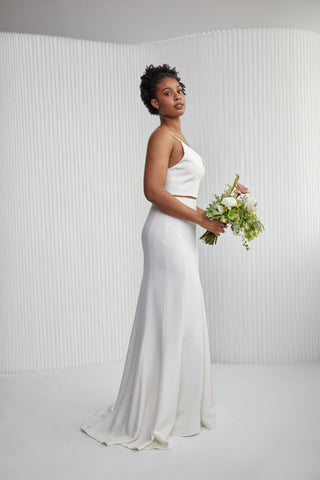 This combo is perfect for brides that want to feel free. The Hutton Top is a form fitting v neck top with thin straps, a low back and is finished with pretty button details. It pairs beautifully with our Jacque skirt giving some subtle yet classy amount of skin. The Jacque skirt designed with strategically placed seams highlights your natural curves and is easy to wear.