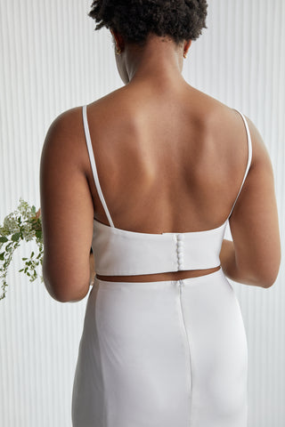 This combo is perfect for brides that want to feel free. The Hutton Top is a form fitting v neck top with thin straps, a low back and is finished with pretty button details. It pairs beautifully with our Jacque skirt giving some subtle yet classy amount of skin. The Jacque skirt designed with strategically placed seams highlights your natural curves and is easy to wear.