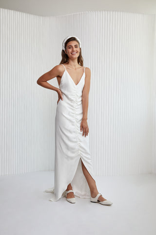 Special laid back sexy take to Slip dress! A luxurious Crepe silk gown, with fine silk straps, a v-neckline, ruched centre detailing, hi-lo hem to show off a shoe and a daring low back. Years in the making, it’s the perfect effortless silk silhouette for the modern woman.