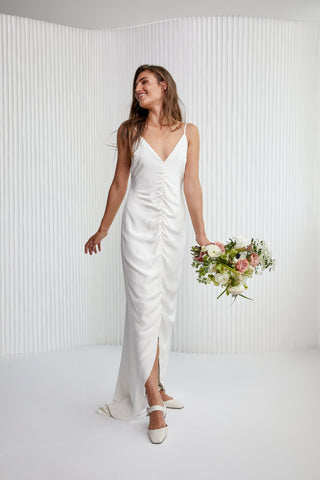 Special laid back sexy take to Slip dress! A luxurious Crepe silk gown, with fine silk straps, a v-neckline, ruched centre detailing, hi-lo hem to show off a shoe and a daring low back. Years in the making, it’s the perfect effortless silk silhouette for the modern woman.