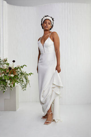 Looking for a classic look with a little more... Made in a comfortable silk crepe, this understated yet memorable dress epitomizes modern femininity from its sleek spaghetti straps and plunge illusion neckline, to its fitted gentle A-line silhouette finished with silk-covered buttons.