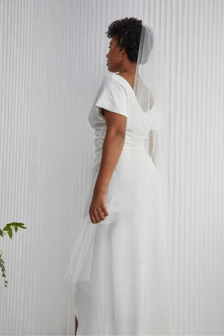 This is the veil that will change into a veil girl. Just the right amount of tulle to frame you and not hide your gorgeous back!! She's light and easy to compliment any gown you choose. (Waltz Length 58" Tulle veil, metal hair comb).