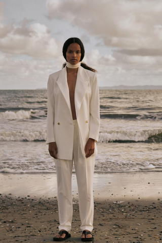 Birgitte Herskind's oversized blazer will instantly become a wardrobe staple because it's so versatile. It's made from 100% recycled polyester in a double-breasted silhouette that's tailored with wide peak lapels and padded shoulders. Wear yours with matching Brenda pants in Off White. A statement outfit for your wedding or any wedding event. 