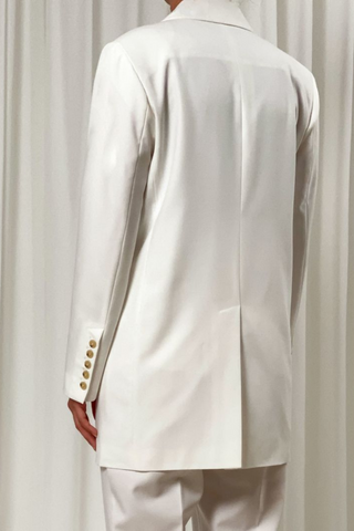 Birgitte Herskind's oversized blazer will instantly become a wardrobe staple because it's so versatile. It's made from 100% recycled polyester in a double-breasted silhouette that's tailored with wide peak lapels and padded shoulders. Wear yours with matching Brenda pants in Off White. A statement outfit for your wedding or any wedding event. 