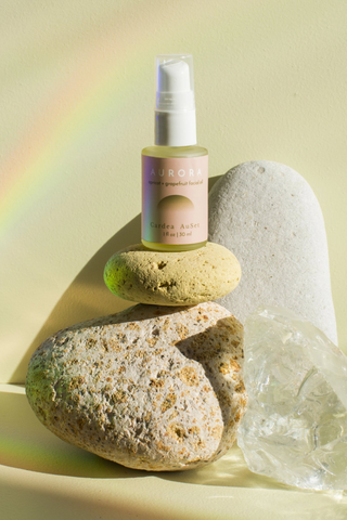 Named after the Greek Goddess of Dawn, AURORA is a sumptuous facial oil meant to be used as part of your morning routine. A cocktail of vitamins A, C and E-rich oil helps firm tired skin, while avocado oil and vitamin D promote cell regeneration for a less-tired look in the future. The icing is a touch of jojoba and apricot oils, which reduce inflammation, and grapefruit oil, which gives you a lit-from-within glow. Made with all natural ingredients for glowing skin. 