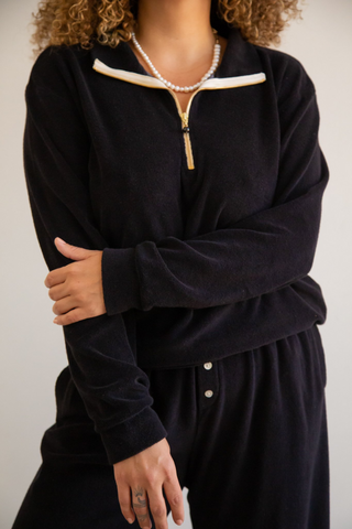 Loungewear elevated. Designed by Donni, this polar fleece 1/2 zip pullover features a stunning freshwater pearl zipper. These days, another comfortable sweater is always welcome to our collection of lounge or WFH options. 