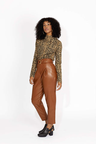 Our winter-staple pant is here. Super high-waisted with a zip and belt closure. The Jasmine Pants are super flattering throughout the hips with a classic pleat in a stylish tan vegan leather. 