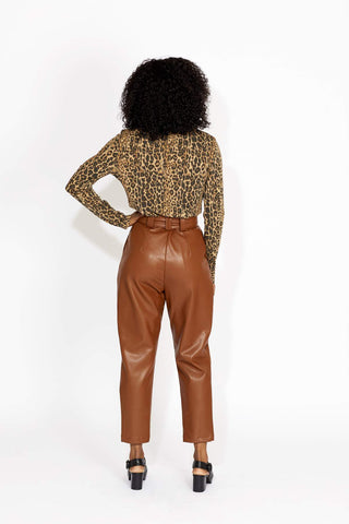 Our winter-staple pant is here. Super high-waisted with a zip and belt closure. The Jasmine Pants are super flattering throughout the hips with a classic pleat in a stylish tan vegan leather. 