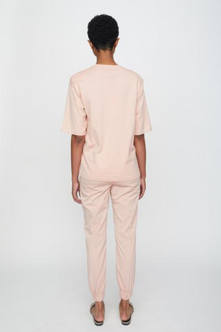 We love this super soft oversized t-shirt made from 100% organic cotton in a delicate rose pink. The t-shirt has detachable shoulder pads that create a defined silhouette and an overt oversized look. It has round neck, short sleeves, and an embroidered JUST female emblem in the back of the neck. A cool and edgy t-shirt that can be styled with anything, pair with the Wish Pants in Misty Rose for a chic monochrome look. 