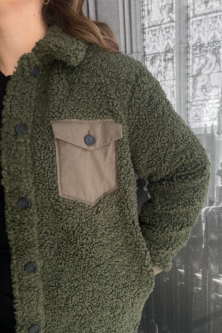 No winter wardrobe is complete without a cozy lounge coat. Wrap yourself up in this mid-length coat jacket, featuring a classic collar, straight silhouette, front beige-olive pockets and black buttons up the front. Designed by Just Female. 