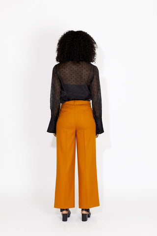 Giddy up lovers, the Chime Shirt is the ultimate cowgirl look for fall. This bold statement blouse features gold metal buttons, and elastic loops closures. Made from a sexy sheer material with contract embroidery details. Designed by Keepsake. 