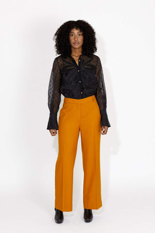 Giddy up lovers, the Chime Shirt is the ultimate cowgirl look for fall. This bold statement blouse features gold metal buttons, and elastic loops closures. Made from a sexy sheer material with contract embroidery details. Designed by Keepsake. 