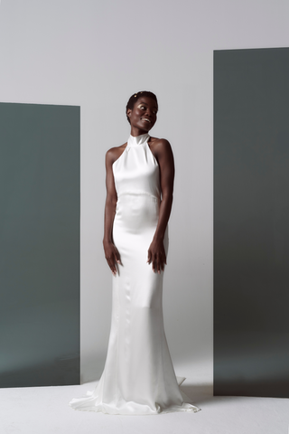 Our take on Ms. Markel's famous evening-wear inspired wedding look, relaxed, sexy, and chic. We offered this structured silk satin dress that beautifully skims the figure and comes finished with pearl & gold buttons.  This Markel gown is a super stylish classic yet sexy backless dress that is sure to make a statement wherever you decide to host your wedding event.