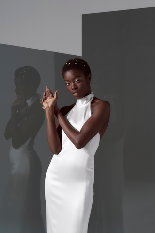 Our take on Ms. Markel's famous evening-wear inspired wedding look, relaxed, sexy, and chic. We offered this structured silk satin dress that beautifully skims the figure and comes finished with pearl & gold buttons.  This Markel gown is a super stylish classic yet sexy backless dress that is sure to make a statement wherever you decide to host your wedding event.