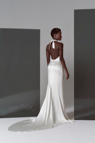 Our take on Ms. Markel's famous evening-wear inspired wedding look, relaxed, sexy, and chic. We offered this structured silk satin dress that beautifully skims the figure and comes finished with pearl & gold buttons.  This Markel gown is a super stylish classic yet sexy backless dress that is sure to make a statement wherever you decide to host your wedding event.
