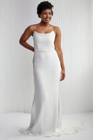 Vivian is our take on a classic strapless. She is a sleek gown with a modern, structured neckline. Vivian brings the drama, with a tuxedo satin silk stripe down the sides to accentuate your curves.  