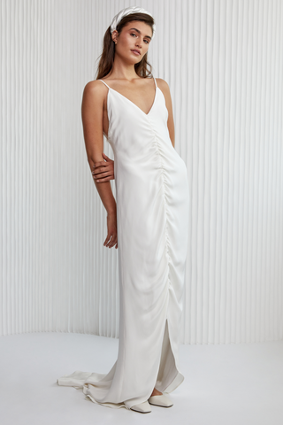 Special laid back sexy take to Slip dress! A luxurious Crepe silk gown, with fine silk straps, a v-neckline, ruched centre detailing, hi-lo hem to show off a shoe and a daring low back. Years in the making, it’s the perfect effortless silk silhouette for the modern woman.