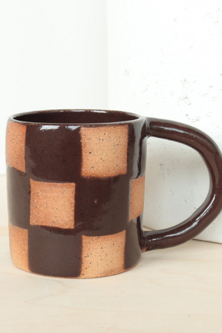 Bringing fresh shapes, cheerful details, and a vibrant wave of colour to any space, Nightshift Ceramic's mission is to make life a little brighter with fun ceramic housewares you can use everyday. The new everyday Checkered Mug is finished in a clear glaze featuring a deep espresso coloured check pattern.