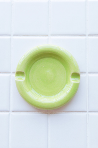 Bringing cheerful details and a vibrant wave of colour to any space, Nightshift Ceramic's mission is to make life a little brighter with fun ceramic housewares you can use everyday. This one-of-a-kind stoneware ashtray features rounded edges in a vivid lime colour. Each is individually glazed and there will be delightful variations in pattern on all pieces. Also great as a jewelry dish or incense burner. Locally made in Toronto, Canada. 