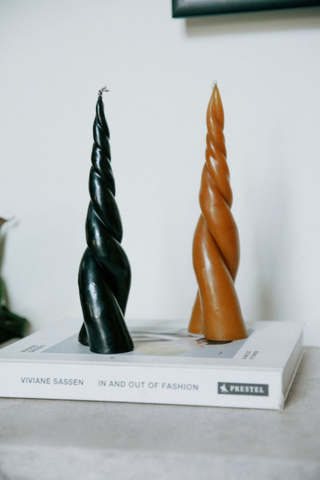 The Duplero entwined candles are a 'twist' on the traditional tapered candle! The best part about these candles (other than their design), is the dual flame that occurs while burning. Nile's version is carefully handmade in Mexico city. These are made with beeswax and a 100% cotton wick. The twirl base allows the candle to stand on its own, we recommend a dish underneath to avoid possible staining on delicate surfaces. Due to artisanal production of these candles irregularities may occur.