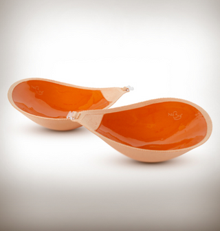 A staple at LoversLand and the perfect bra for all dresses and tops that require no straps and a little extra cleavage. The Adhesive Seamless Nubra features a lightweight fabric with seamless edges, made with skin-friendly and reusable adhesive that easily sticks onto the skin without losing grip. The front closure help to provide cleavage control. Made in USA.