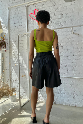 A statement piece for your next summer outing. Elevate your shorts game with the Bermuda Short featuring a high waist and casual pleats made from a polyblend faux leather. This is a classic look designed by Pastiche in black - perfect for any summer or holiday wardrobe. 
