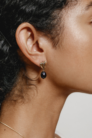 Elegant and bold - we are loving the Jade Heart earrings designed by Wolf Circus. Featuring a 14k gold plated bronze heart pendant with a freshwater drop black pearl. All metals are made from recycled materials, making the this heart-shaped gold earring our favourite eco-friendly option. 