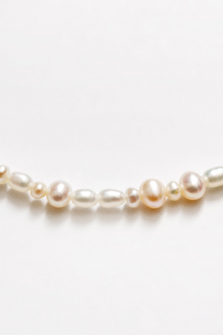Designed by Wolf Circus. The Renata 16" small freshwater pearl necklace is gold filled featuring a lobster clasp. Made in Vancouver, Canada. Designed by Wolf Circus. The Renata 16" small freshwater pearl necklace is gold filled featuring a lobster clasp. Made in Vancouver, Canada. 