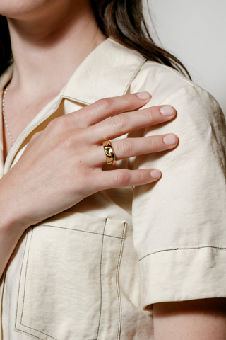 A 14k gold classic ring designed by Wolf Circus. The Aida ring features a gold-plated bronze textured wide stacking band. Pair with more rings from Wolf Circus to capture that layered look. The Aida Ring is the perfect statement ring to keep your look stacked.